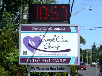 Dental Care Group Street Sign with Time and Temperature